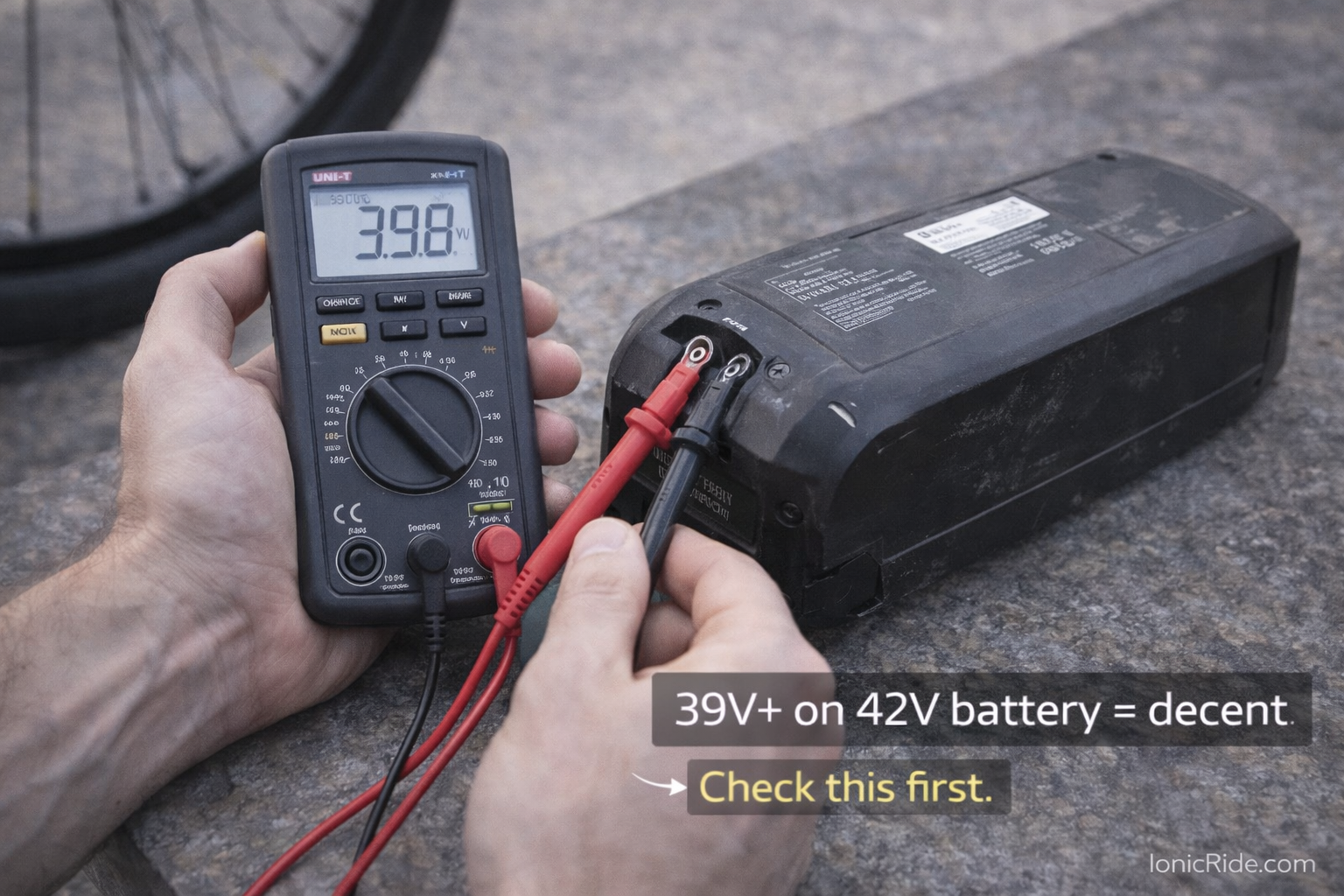 Testing Used E-Bike Battery Voltage with Multimeter Digital multimeter testing used e-bike battery voltage showing 39.8V reading on 42V system indicating battery degradation level